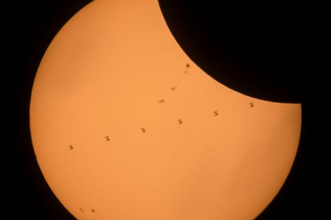 The International Space Station crosses the solar disk during the eclipse. 