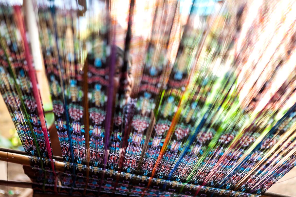 A weaver working on a loom.