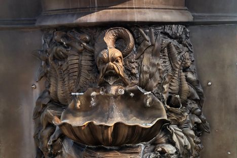 Floral and bestial designs around the tap basins.
