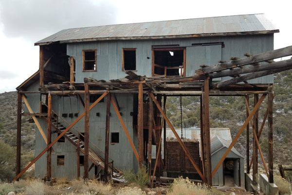 View of the uphill side of the mill. Note the diagonal cross-braces installed by the Forest Service to stabilize the structure. The tramway comes in from the right.