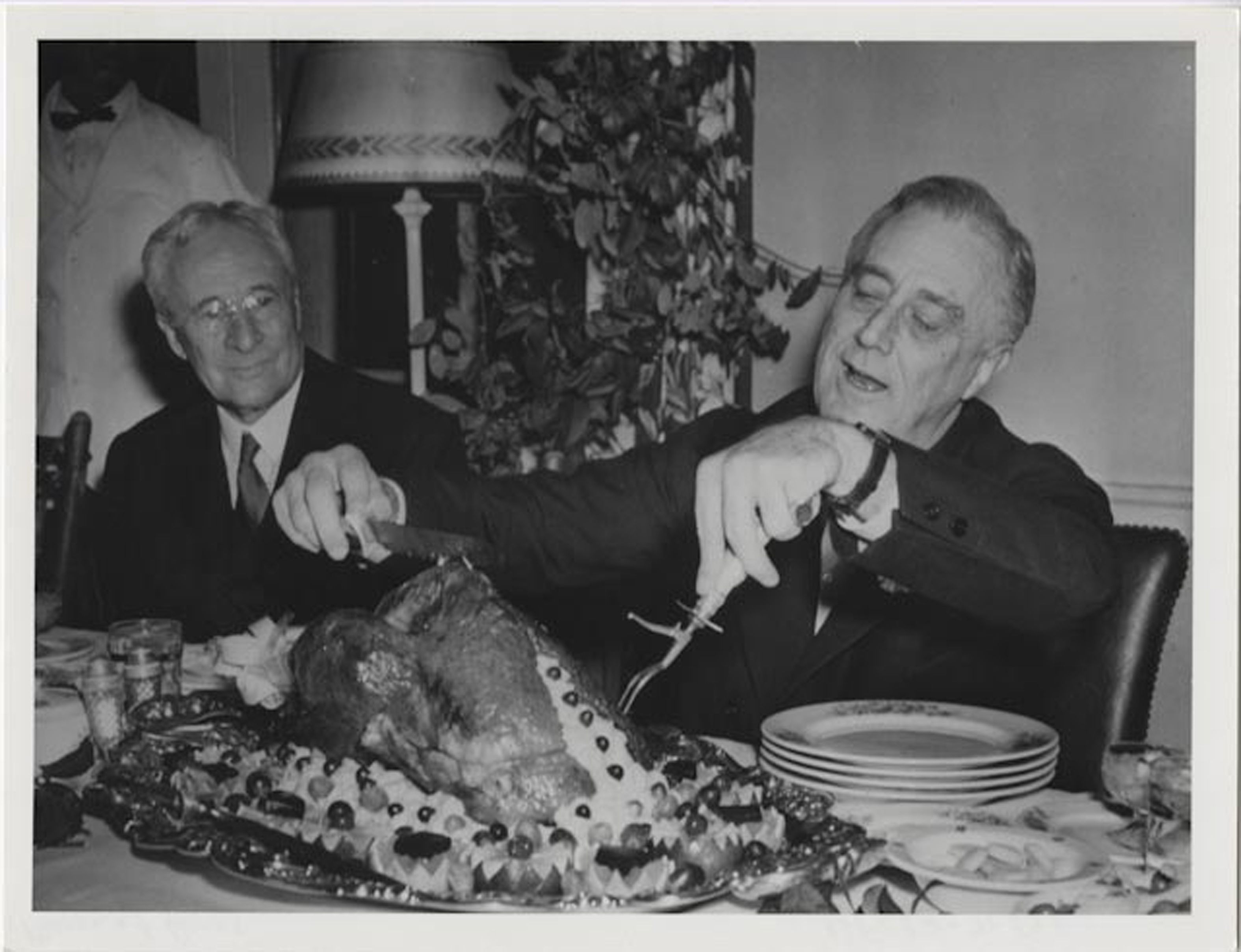 Franklin Delano Roosevelt carving a turkey on the 5th Thursday of November, 1933.