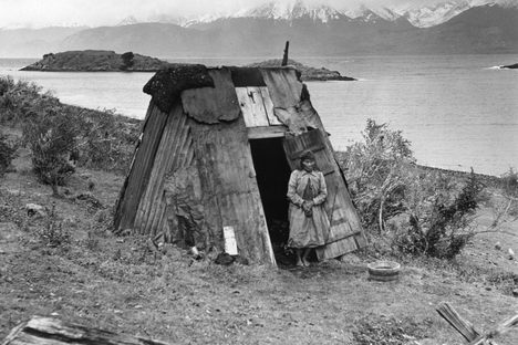A Yaghan woman outside her hut, Chile. 