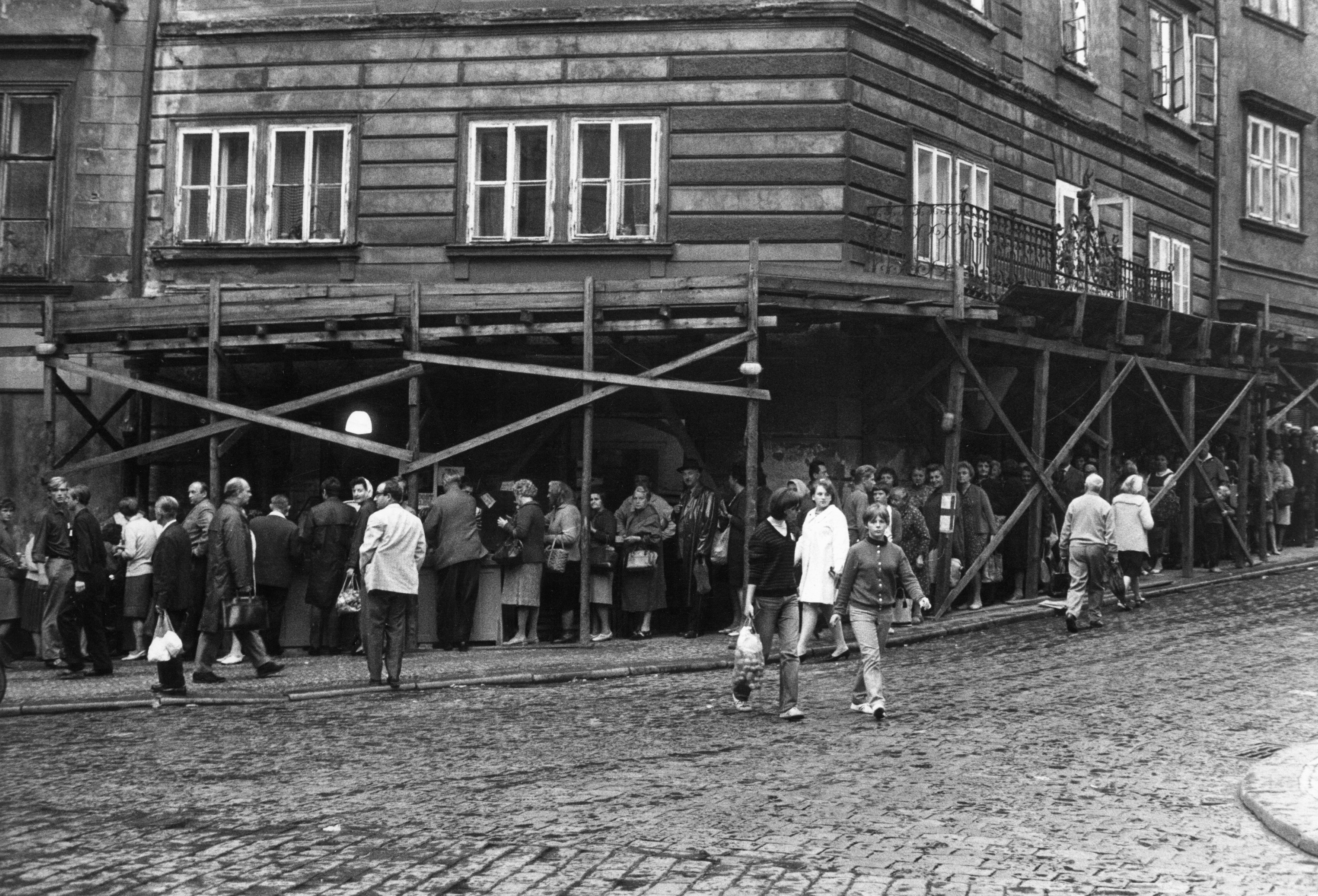 People wait in line for one of the scant grocery stores open in 1968 Prague.