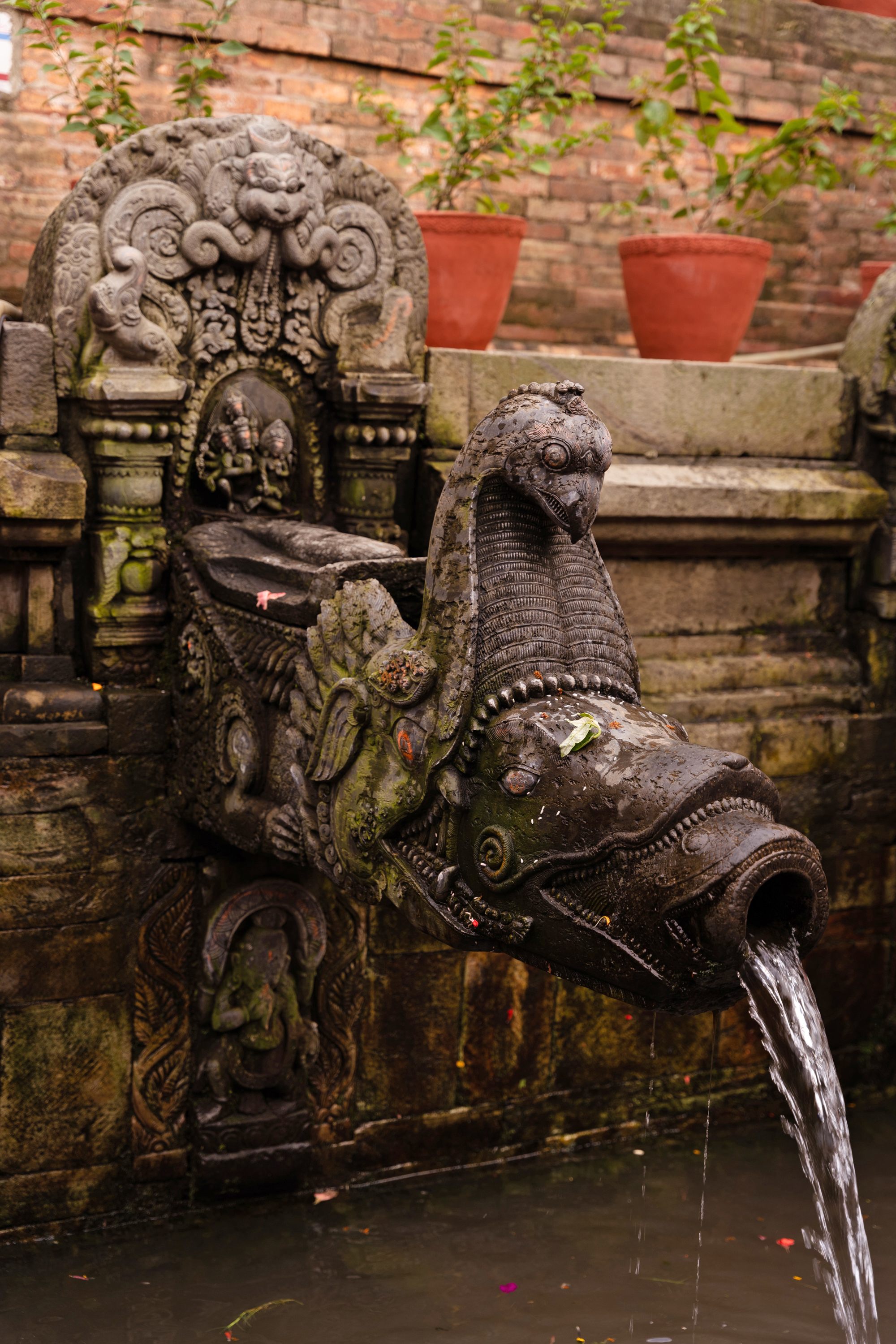 A handful of these ancient water sources continue to supply communities in Kathmandu, Patan, and Bhaktapur, like this water spout in Manga Hiti.