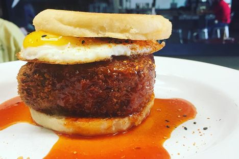 A breaded scrapple and egg sandwich.