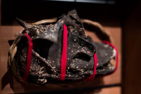Project coordinator Rosy Hartman found this child's shoe at a former school site Carcross, Yukon. It's now part of the Witness Blanket, wrapped in red medicine cloth and surrounded by sage and sweetgrass.
