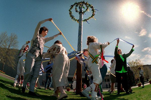 Children dance around a modern maypole in Boston; a few centuries earlier, a similar celebration was cut short by Puritan axes. Was it part of a practice run for a far more violent and bloody campaign?
