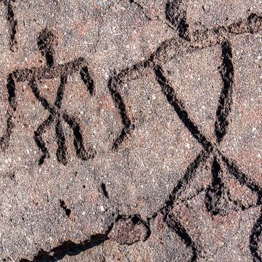 Petroglyphs of two people in the Waikoloa Petroglyph Field.  These are potentially Hawaiʻi's most famous petroglyphs. 