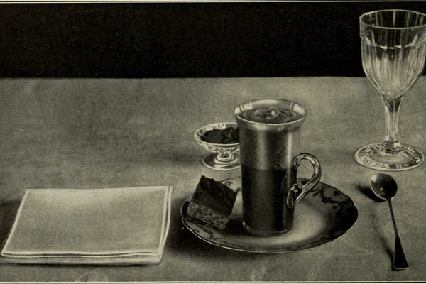 A place setting with a napkin from <em>American Cookery</em>, 1914. 