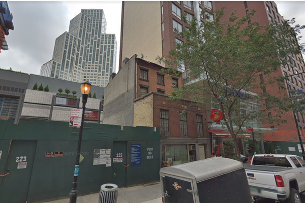 The Truesdell house in August 2018, sandwiched between a high-rise hotel and a lot that will become a park.
