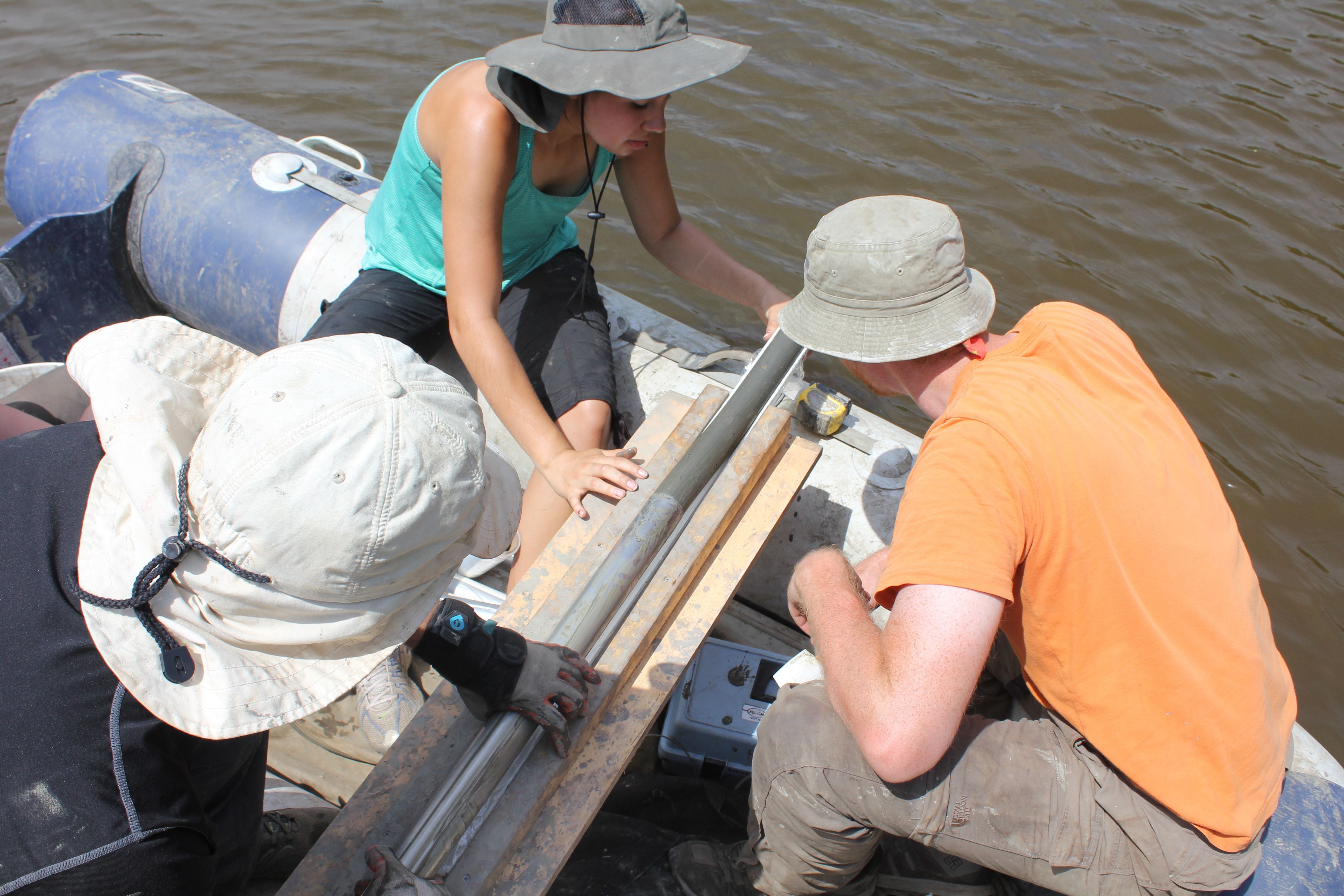 The researchers unearth a lake core.