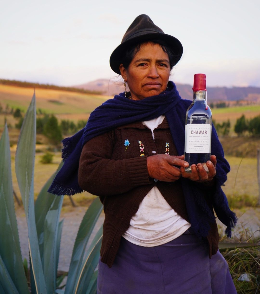 María Melchora, the founding president of the Mishkita co-op, holds a bottle of Chawar.