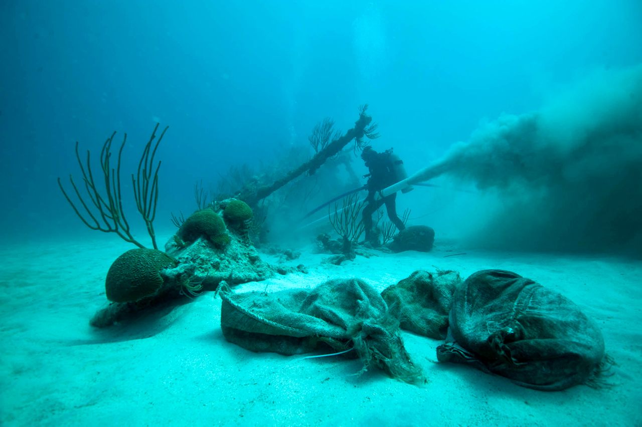 Dr. Philippe Max Rouja, Custodian of Historic Wrecks from the Government of Bermuda, clearing the non-historic layers of sand during the rescue archaeology investigation of the bow of the shipwrecked <em>Mary Celestia</em>, South Shore Bermuda. 