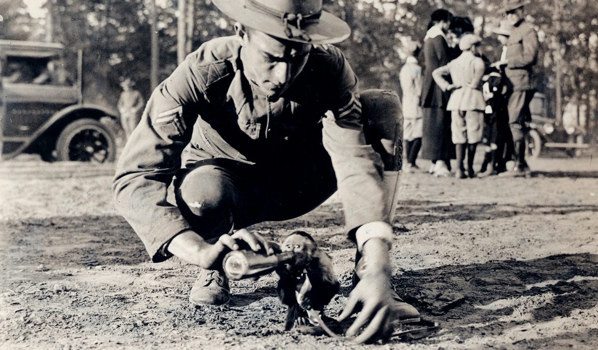 A solider feeds a monkey of one of the Field Artillery Batteries at Camp Wadsworth in Spartansburg, South Carolina.