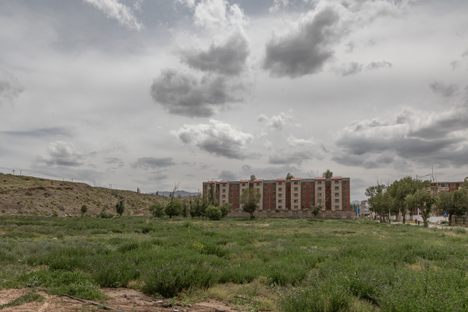 Open field in front of a condominium.