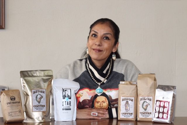 Loretta Guzman shows off the array of coffees she sells at Bison Coffeehouse.