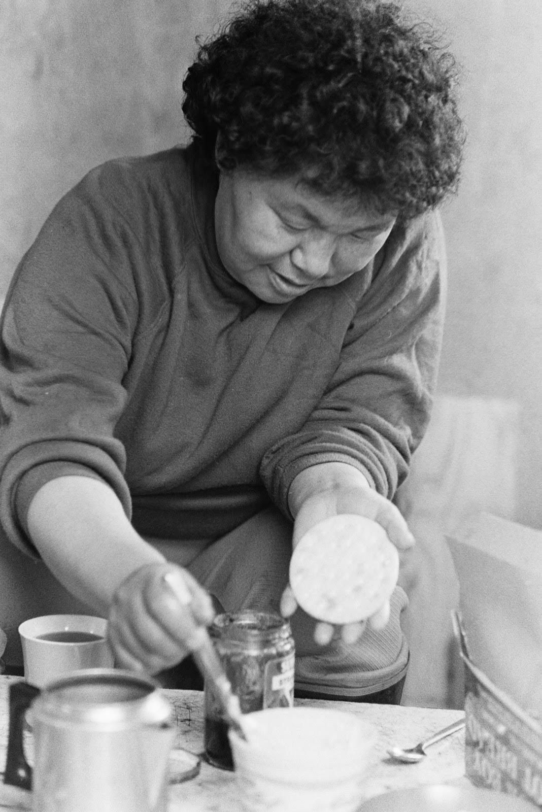 An undated photo (c.1970s–1980s) of Mary David's mother enjoying some pilot bread.