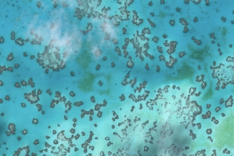 The lagoon at Heron Island, speckled with reef halos.