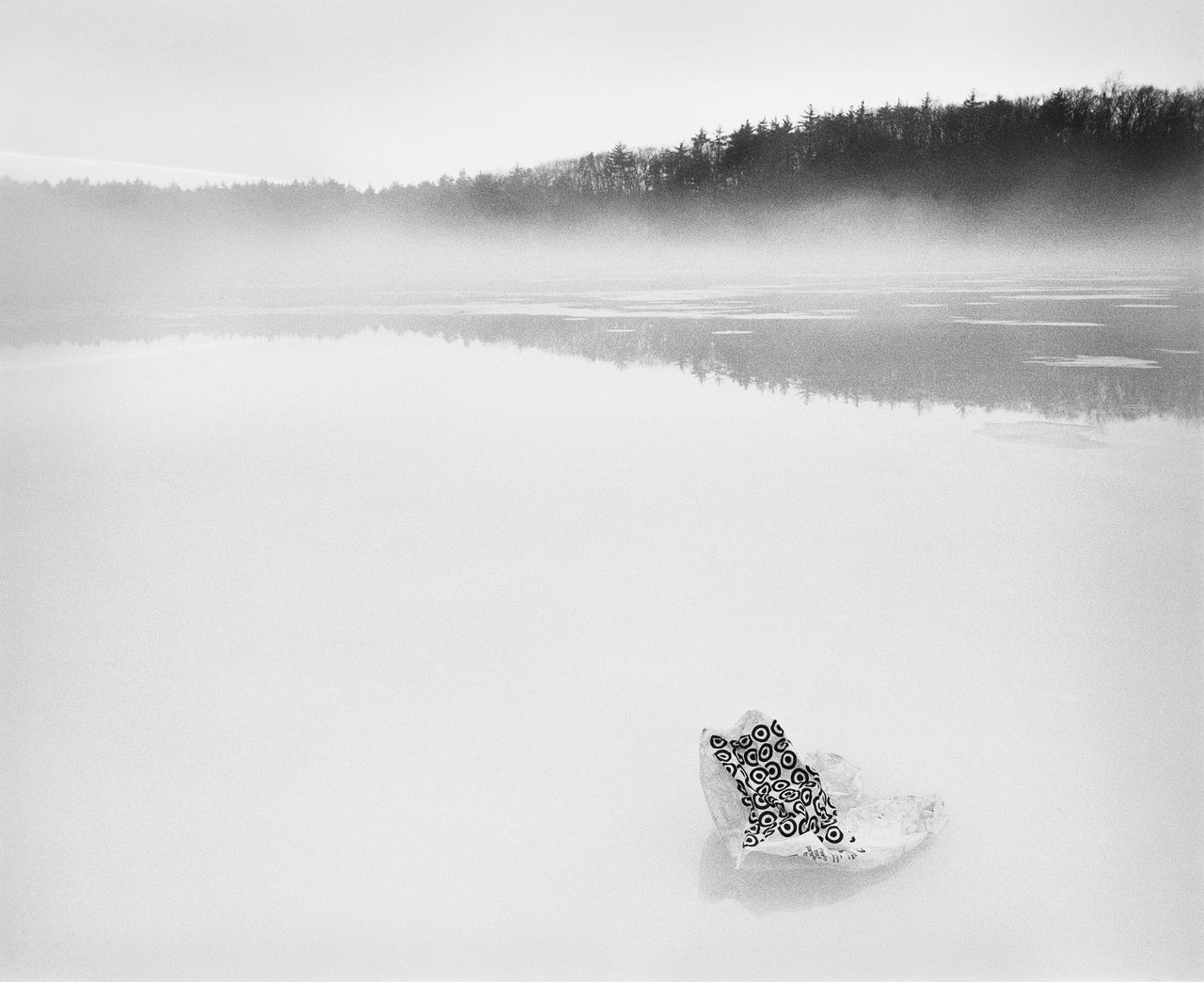 A Target bag rests on the surface of Walden Pond. Part of S.B. Walker's 2017 photo series, "Walden."