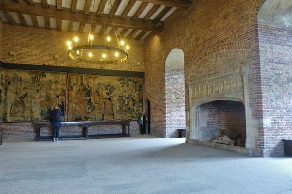 Tapestry reproduction and restored fireplace.