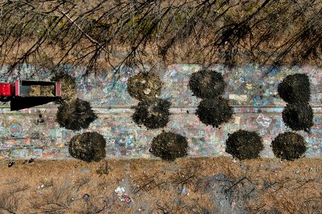 A Fox Coal Company dump truck plants a load of dirt on the Graffiti Highway in April 2020. It took about 400 loads to cover the one-mile stretch of road. 