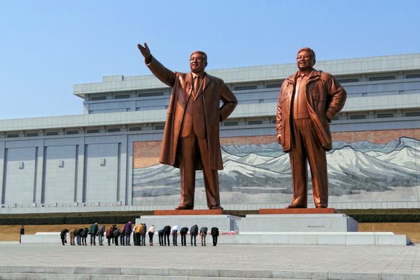 North Korea's late leaders Kim Il-Sung and Kim Jong-Il tower over visitors to the Grand Monument at Mansu Hill, reinforcing the Kim family's power.