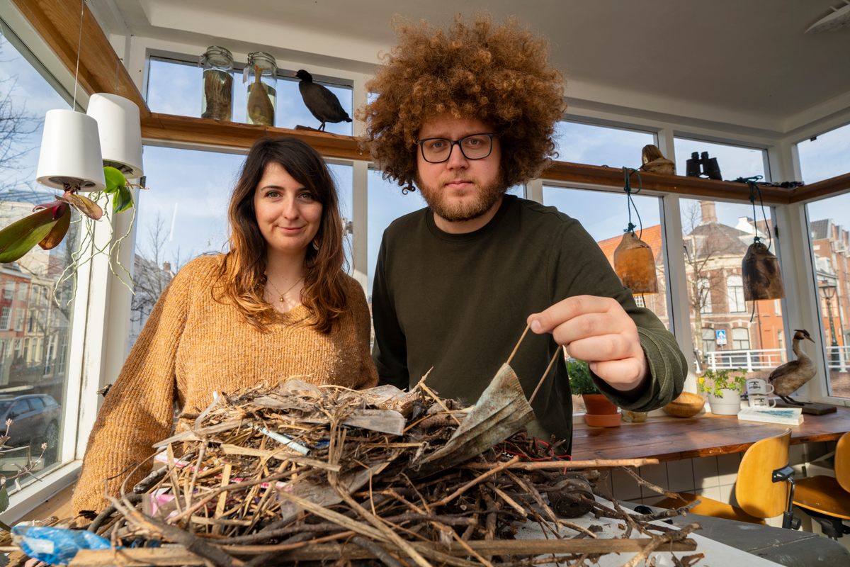 Researchers Liselotte Rambonnet (left) and Auke-Florian Hiemstra (right) have begun measuring the affect that PPE is having on animals—including the birds that used face masks in this nest.