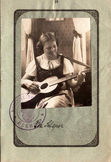 This 1921 German passport shows a young woman with her guitar.