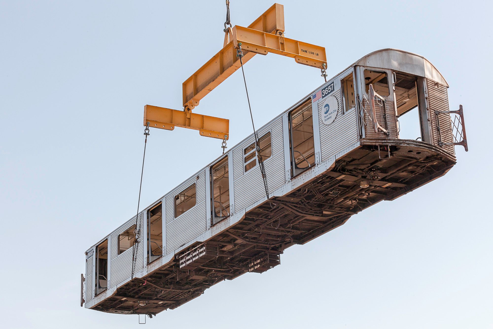 Subway cars hoisted in the air in "Mind The Gap, 2008."