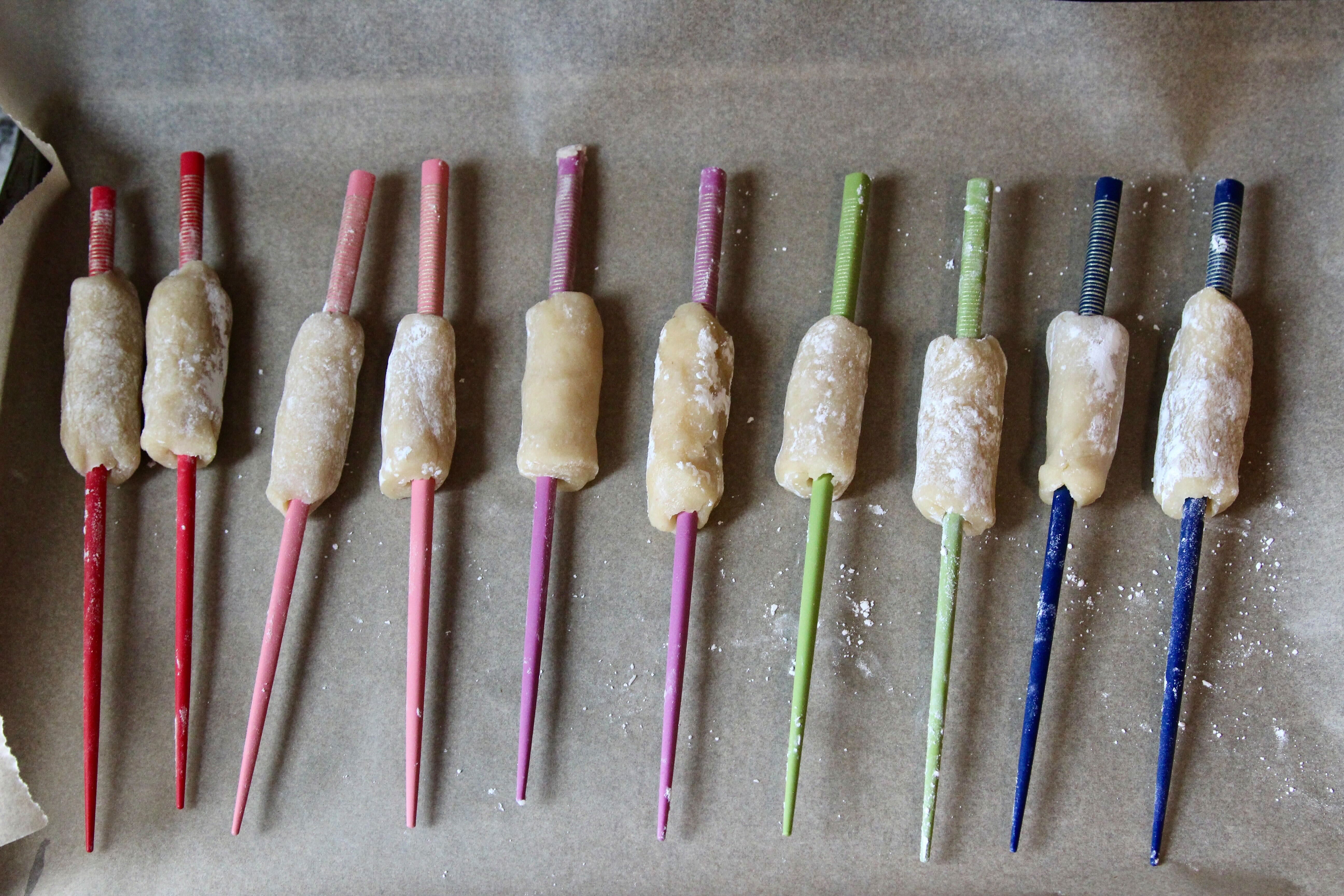 Though they're not exactly traditional for the recipe, chopsticks help the marzipan huesos hold their shape.