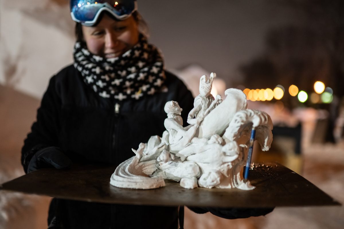 Maggie Thompson holds a clay model of the team's sculpture for the 2024 Minnesota State Snow Sculpting Competition.