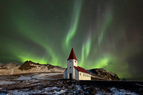 Oxygen in the atmosphere gives auroras over Vik, Iceland, their eerie green glow.