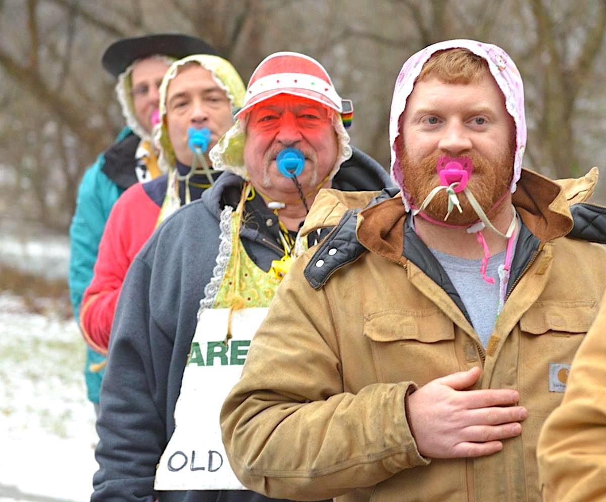 In 2015, supporters of the Octoraro Orphie marmot wear hats and pacifiers for their admission to the Slumbering Groundhog Lodge.