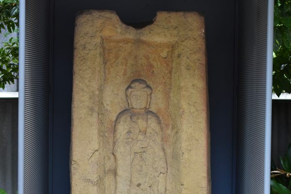 A medieval Buddha on an ancient coffin lid.
