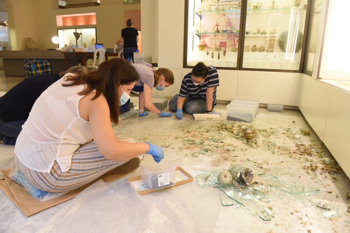 After the explosion, a team sifted through the shattered glass on the gallery floor of the AUB museum separating fragments of ancient glass from shards of modern glass from the display cases.