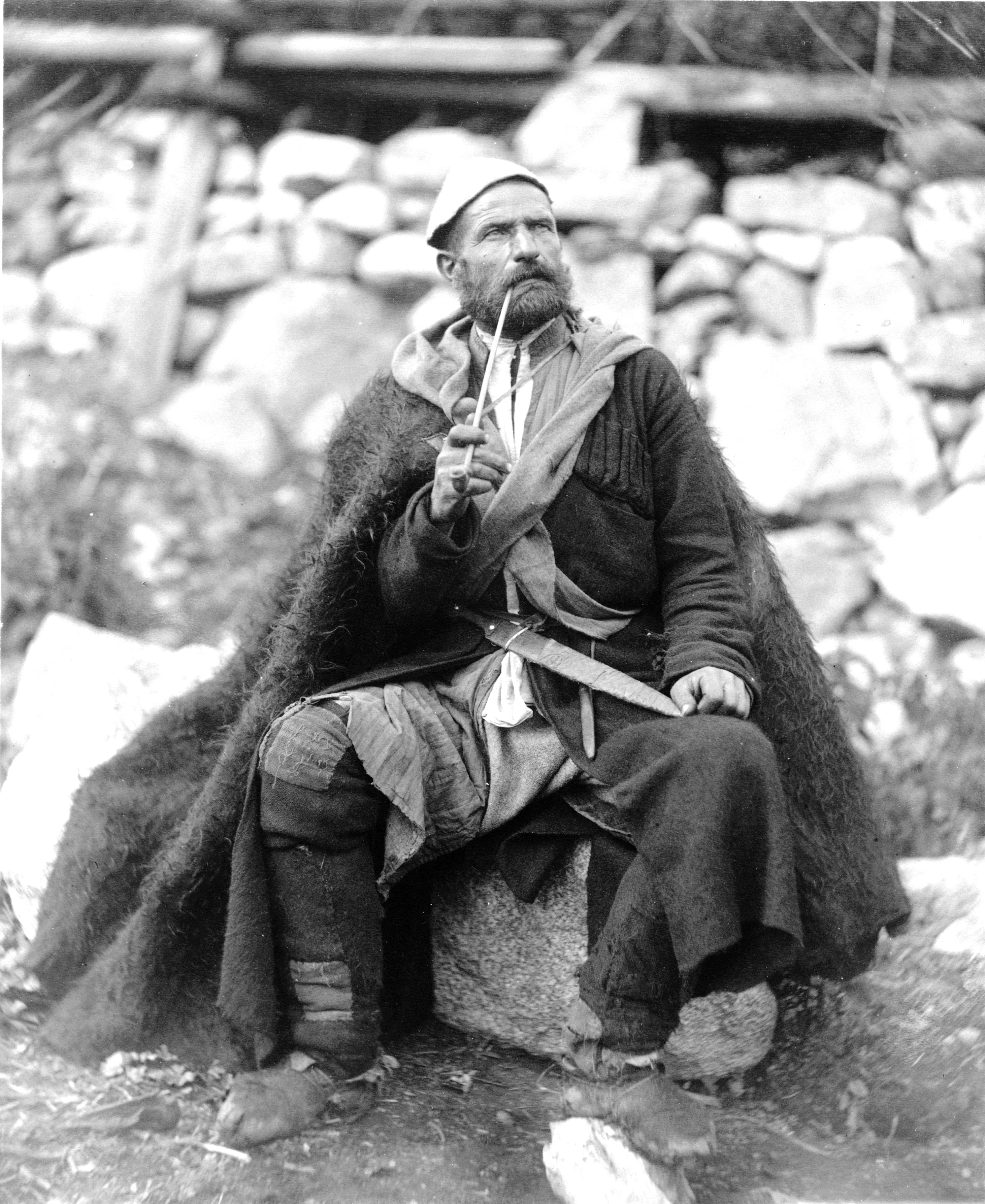 This photograph, taken between 1888 and 1900, depicts a man smoking (tobacco?) from a pipe in Mestia, Svanetia, Georgia.