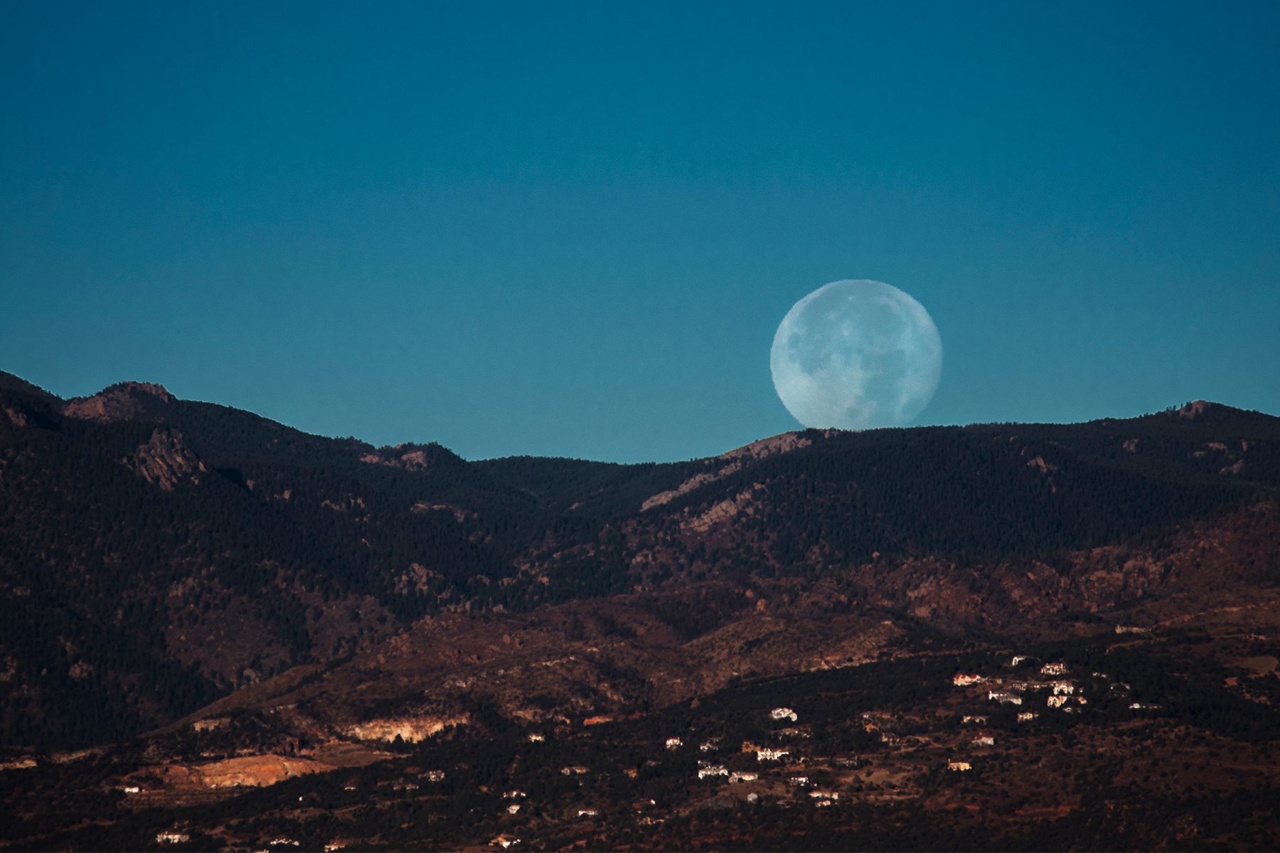 A Supermoon sets over the front range of the Rocky Mountains, Colo., Nov. 15, 2016.