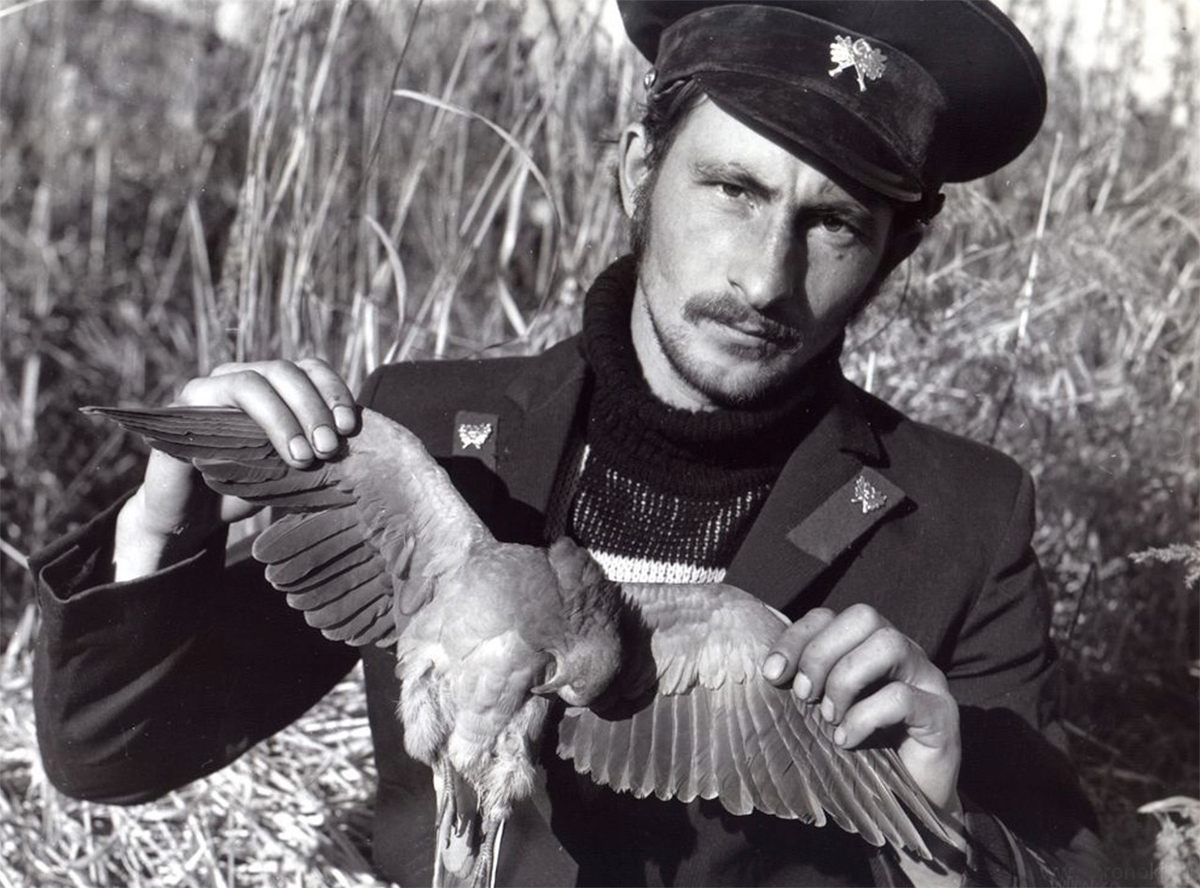 A. Kiselev holding the body of a pigeon.