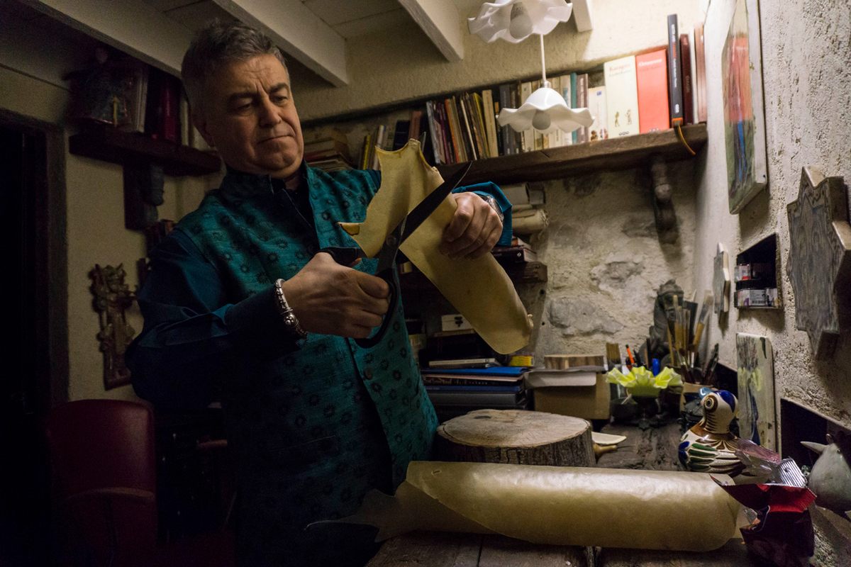Özek cuts a piece of leather to begin creating another shadow theater figure. He tries to devise unique characters that will attract a new generation to the ancient art.