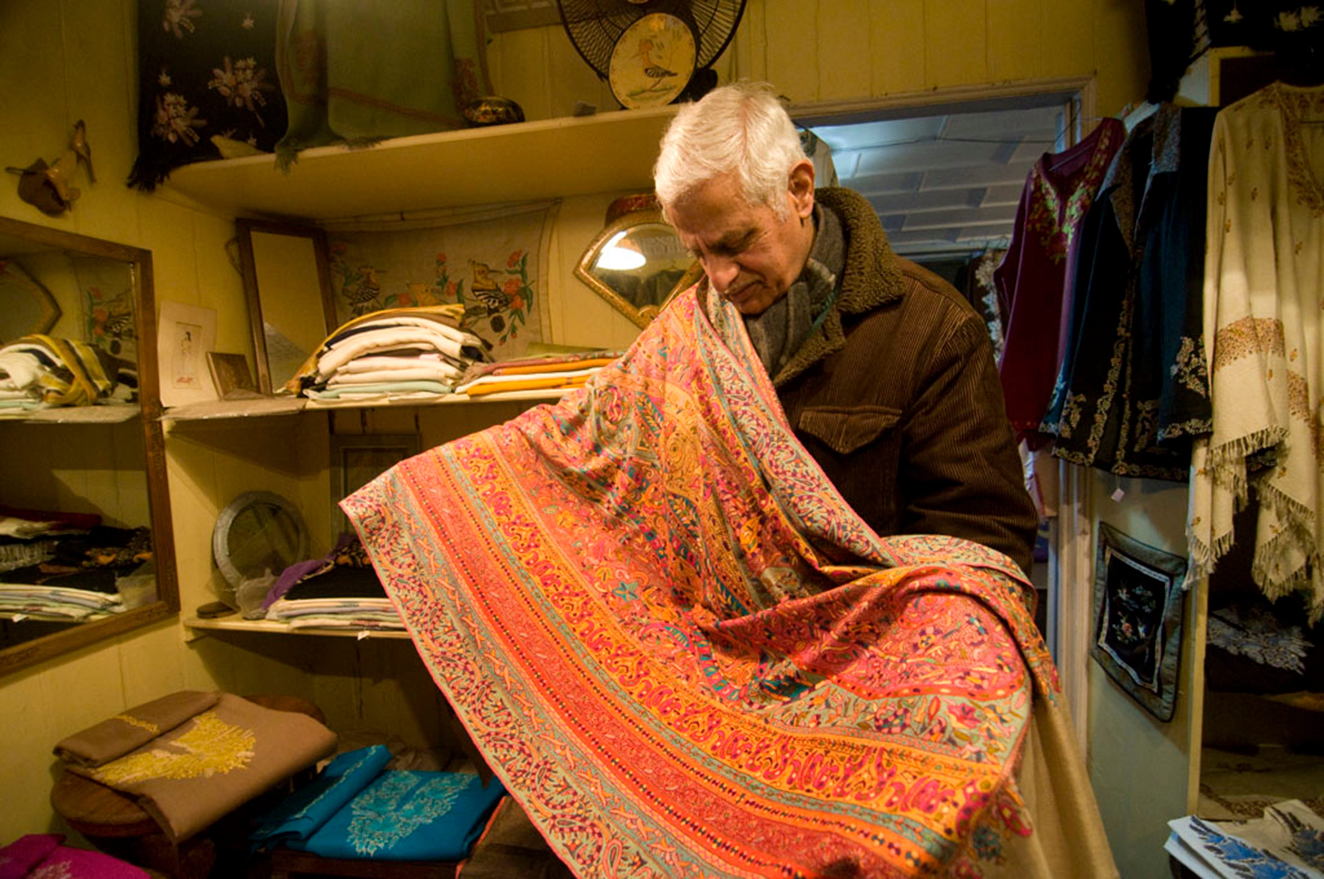 Sadiq Mohammed Wani displays a Kashmiri shawl made 105 years ago. 