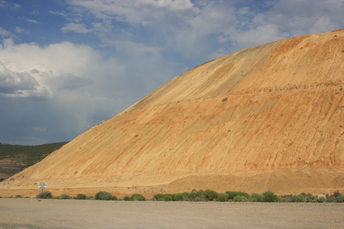 Spoil heaps off US-50 near Ruth.  Bushes give scale.