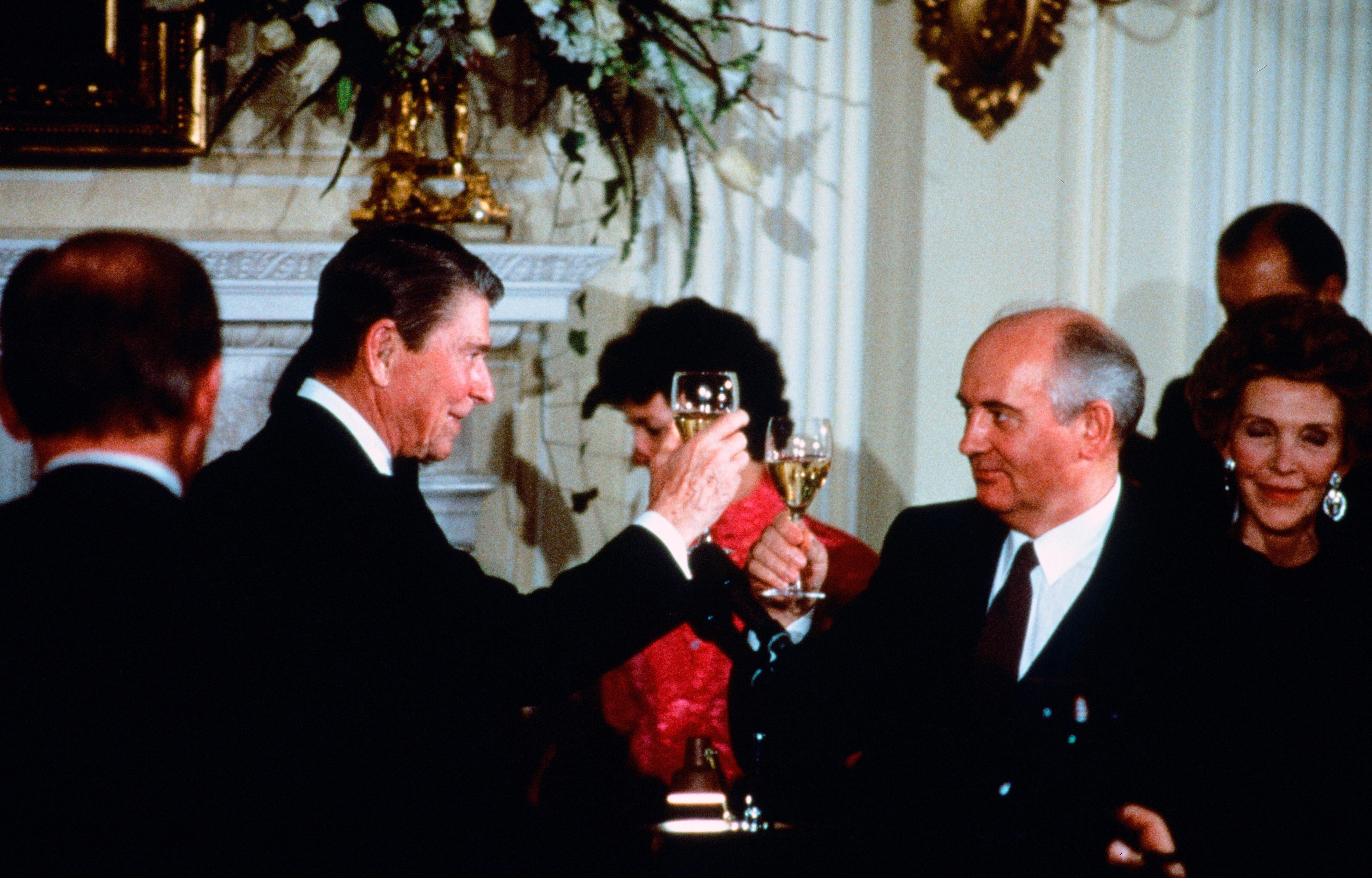 President Ronald Reagan and Soviet General Secretary Mikhail Gorbachev toast each other during a summit in December 1987.