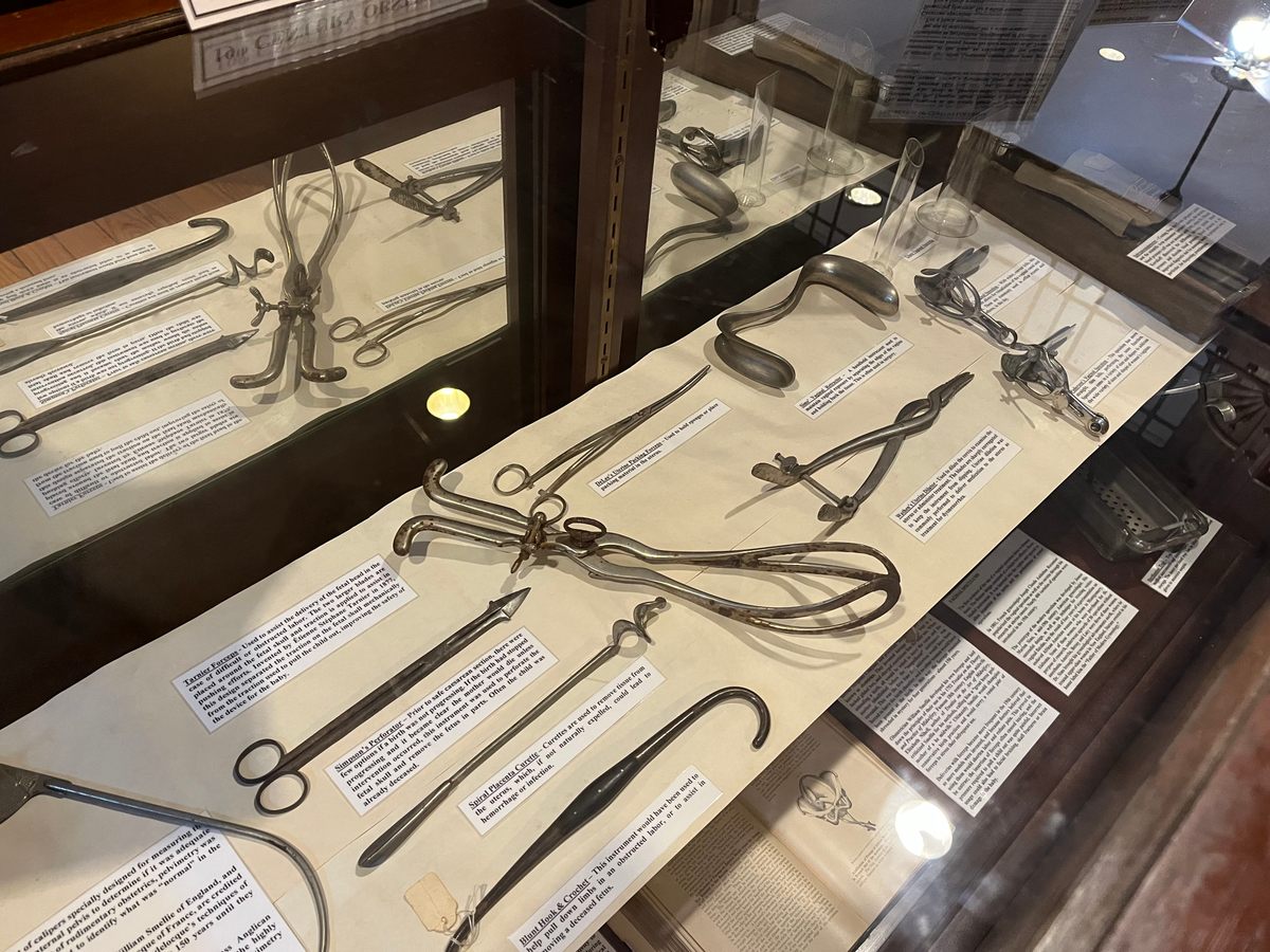 Nineteenth-century obstetric tools on display in the Pharmacy Museum of New Orleans. In the top right corner is a vaginal retractor designed by J. Marion Sims.