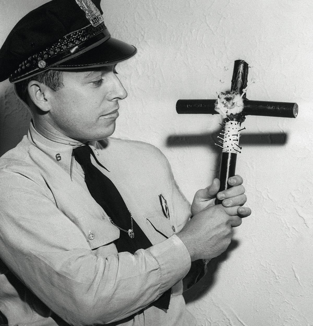 Policeman holding a voodoo cross, New Orleans, Louisiana, 17 June 1949.