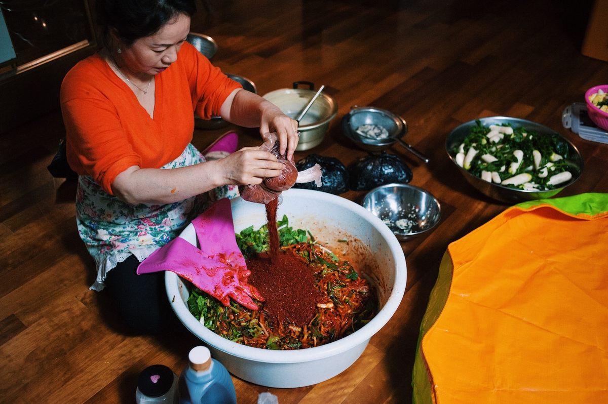 Cut daikon are mixed with glutinous rice paste, salted baby shrimp, ginger, garlic, red pepper flakes, salt, fish sauce, plum extract, shallots, leaf mustard, watercress.