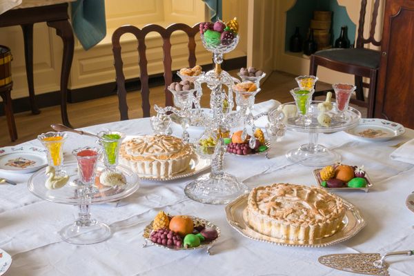 The Governor’s Palace dining room in Colonial Williamsburg filled with fake jellies, candied ginger, chocolate almonds, pies, and marzipan fruits and animals.