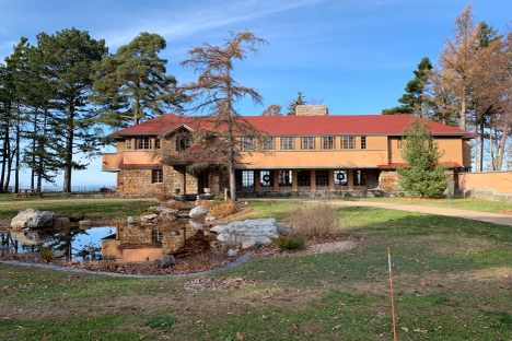 Back of house closest to road featuring the pond.