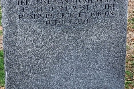 Commemorative stone marking the first man to speak on a commercial telephone line in Indian Territory. May 2024