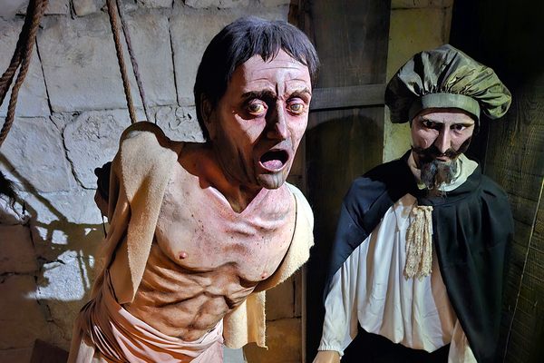 A man being tortured on a wooden horse (also called a Spanish donkey).