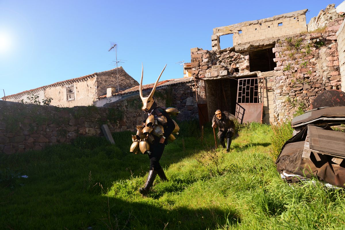 Revelers in Ottana walk through the ruins of the town's old center.